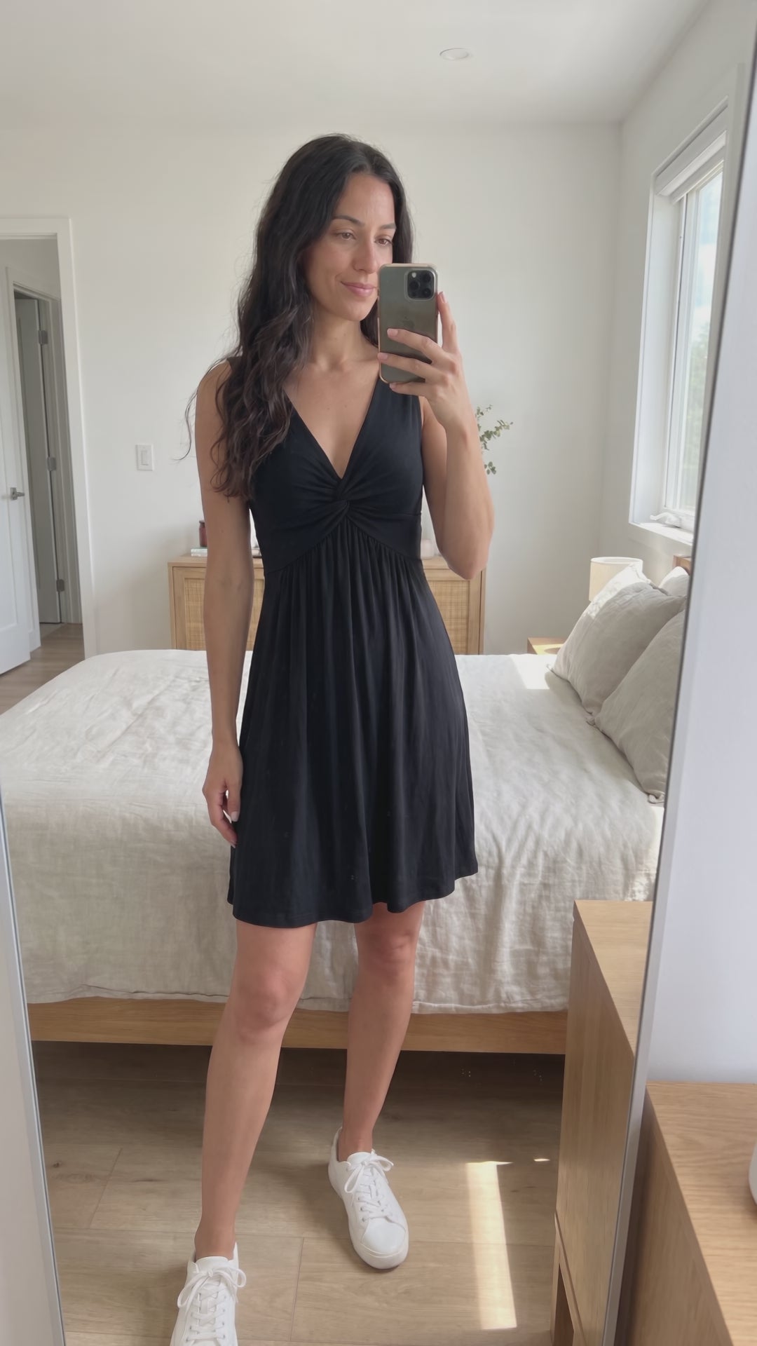 Video of the black Twist-Front V-Neck Mini Dress with sneakers, seen in a mirror